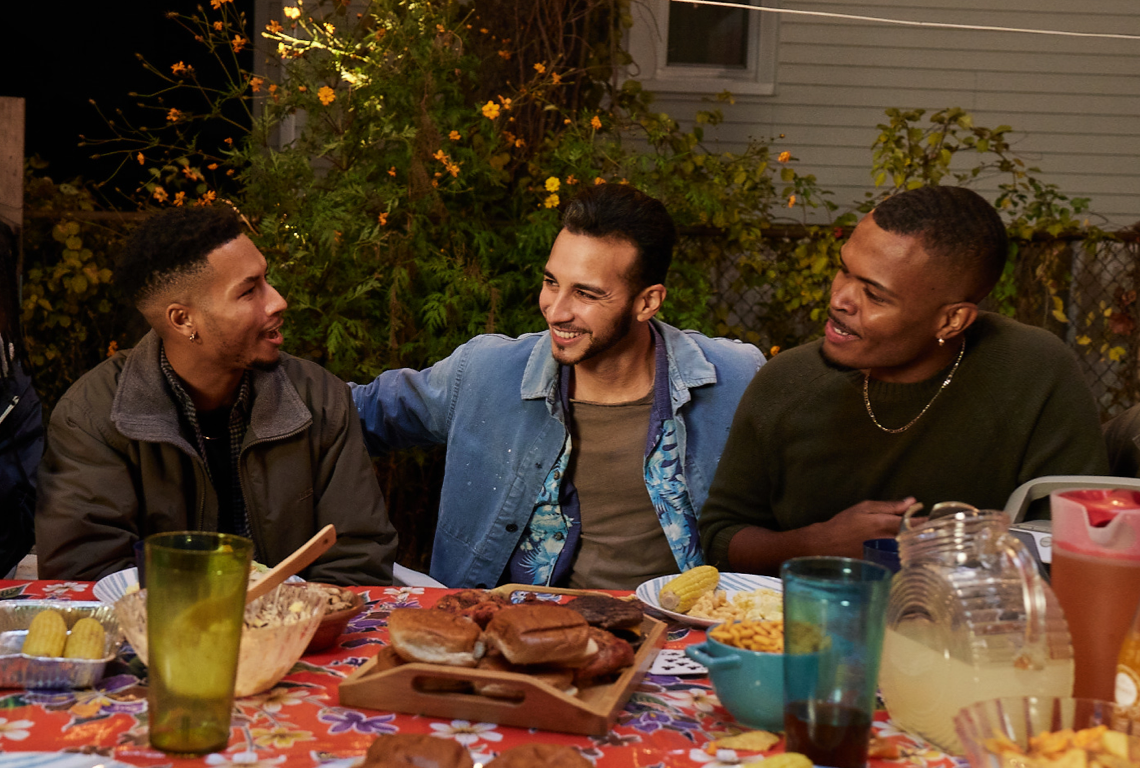 Group of men at cookout laughing together